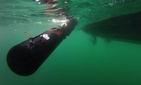 U.S. and Italian sailors deploy a Remote Environmental Measuring Units (REMUS) 100 unmanned underwater vehicle off Sesimbra, Portugal, Sept. 19, 2019.