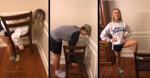 a girl and a boy bending over to pick up the chair