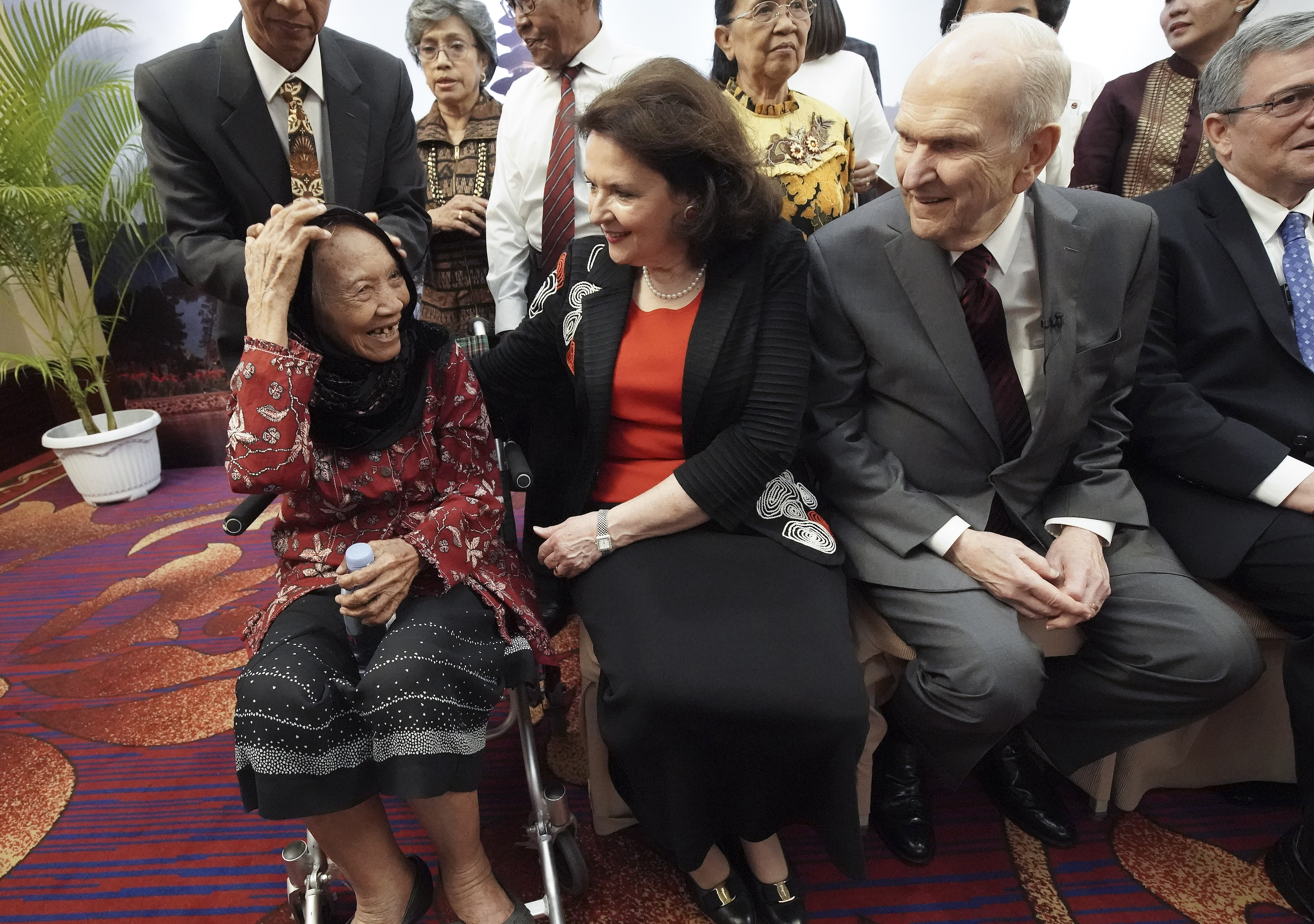 President Russell M. Nelson of The Church of Jesus Christ of Latter-day Saints and his wife, Sister Wendy Nelson, talk with 86-year-old Tumini as he meets with multigenerational families in Jakarta, Indonesia, on Nov. 21, 2019.