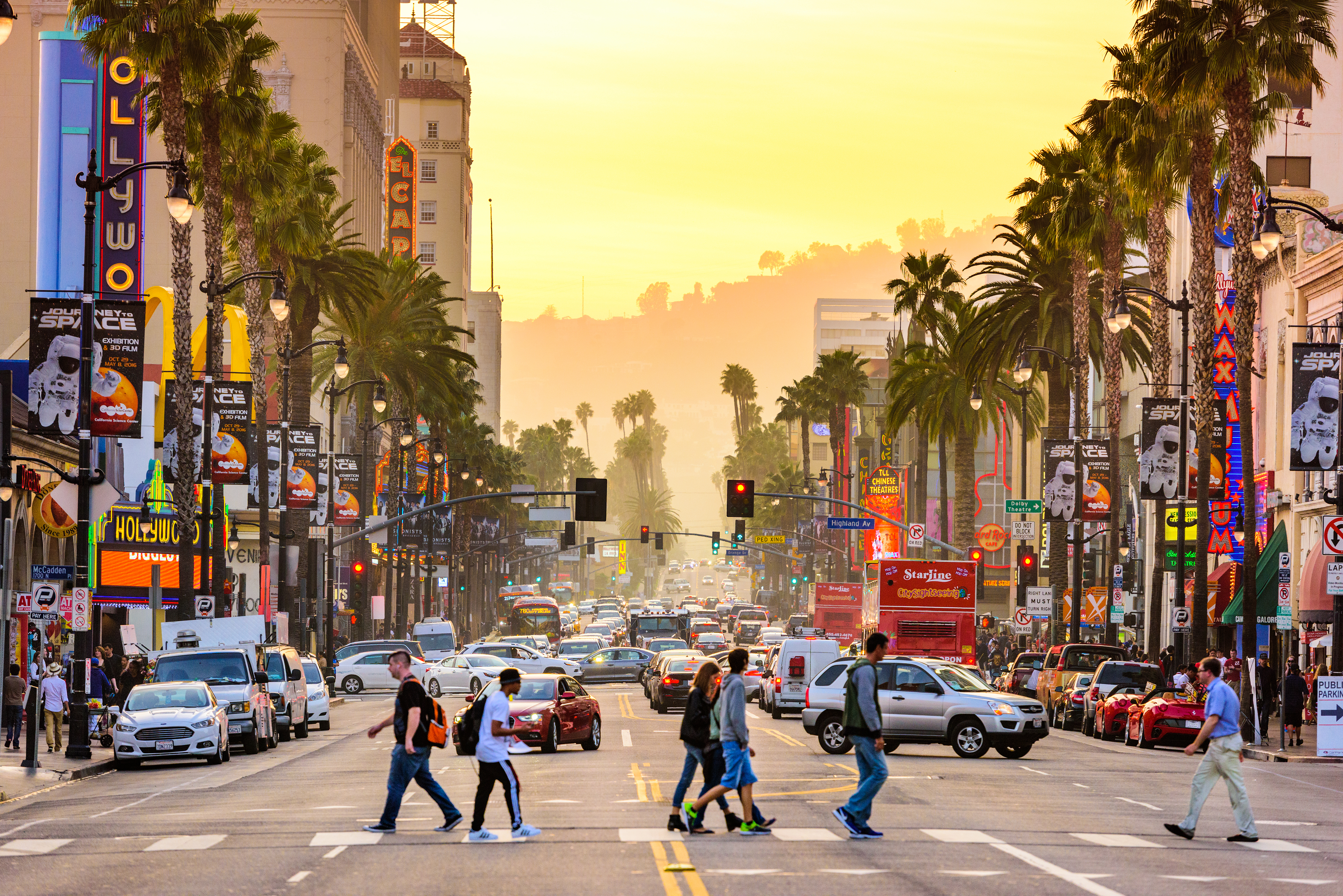 Pedestrians crossing a busy street in Los Angeles.