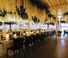 destination wedding decor view of aegean sea in mykonos greece flowers and woven pendants modern