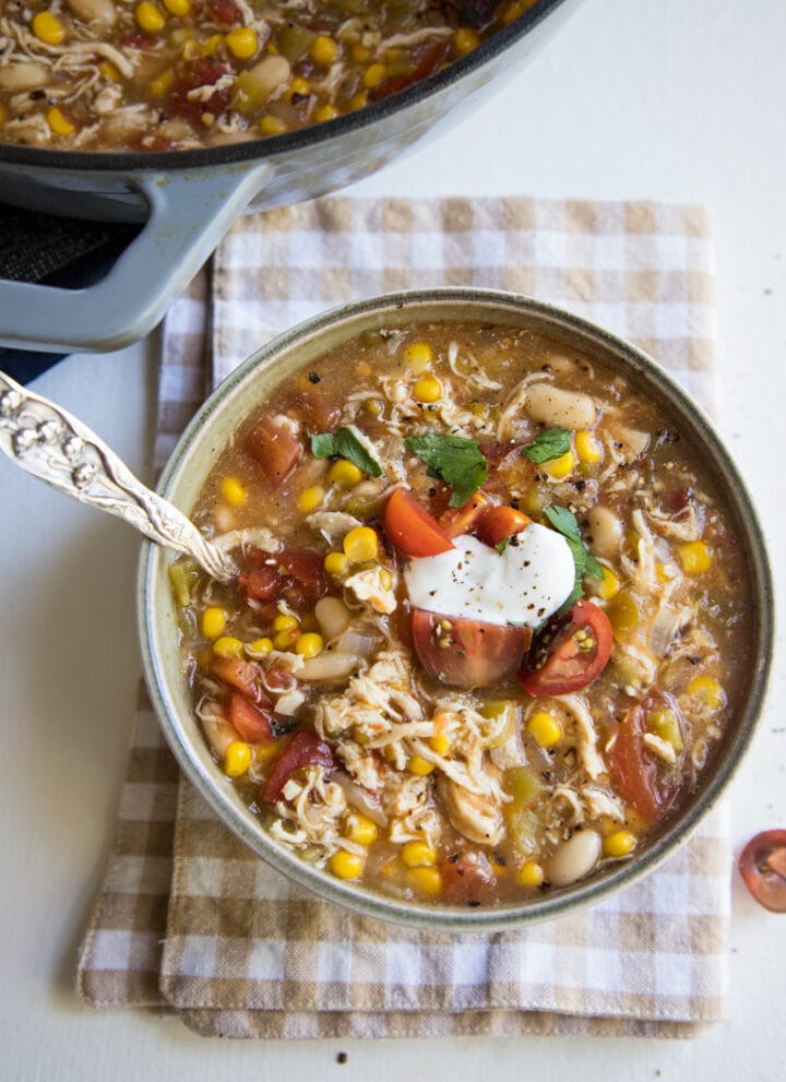 a bowl of white bean chicken chili with a spoon
