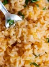Close up view of Mexican Rice or Arroz Rojo, showing the fluffy texture and pale red color of the rice.