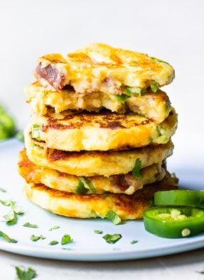 Stack of mashed potato cakes loaded with jalapeno, bacon and cheese.