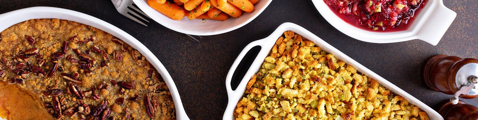 All traditional Thanksgiving side dishes, roasted carrots, sweet potato casserole, cranberry sauce and stuffing