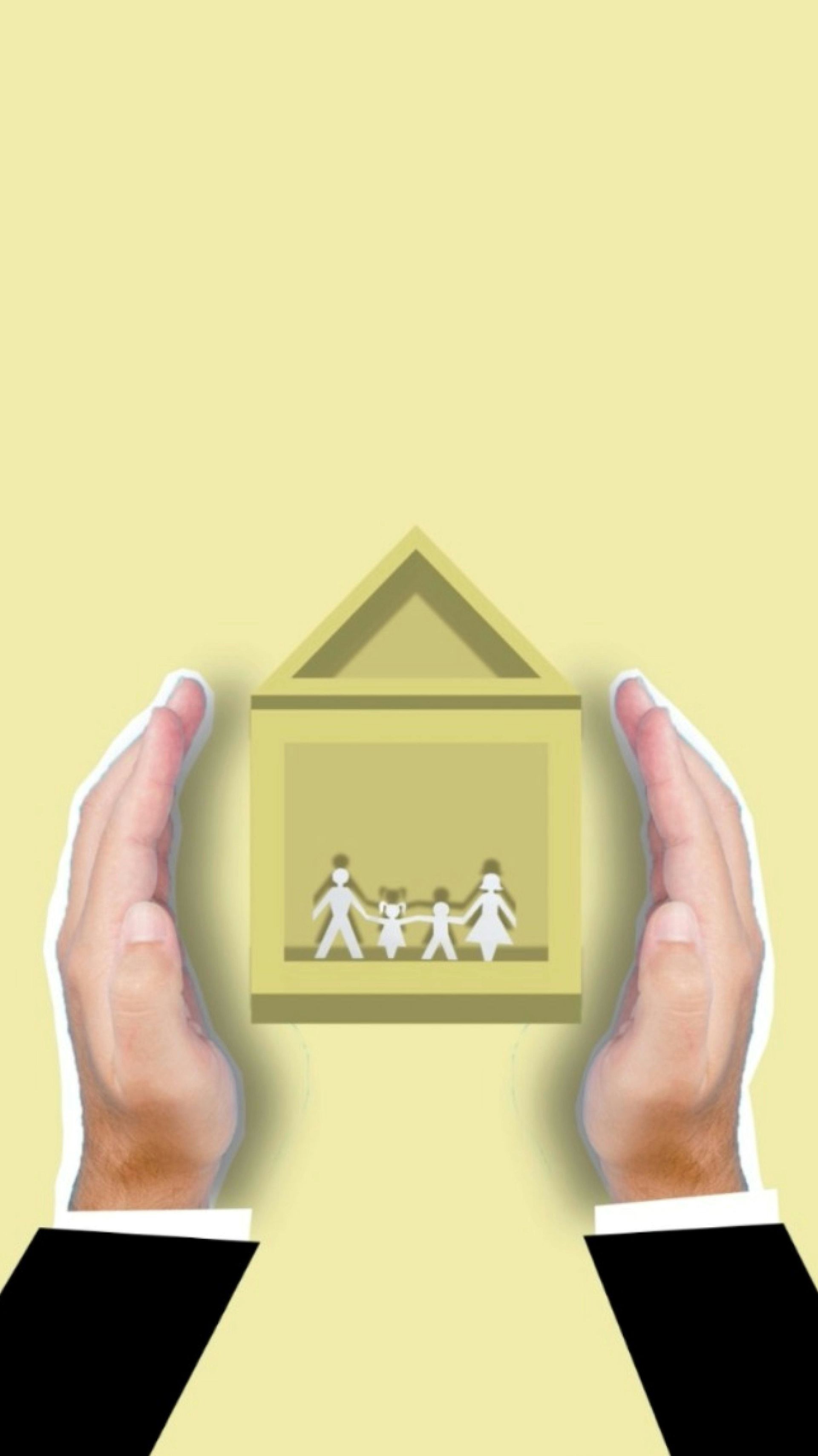 A pair of hands cradles a paper house cutout, showcasing a family figure within.