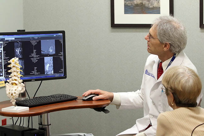 Doctor Charles Reitman with a patient
