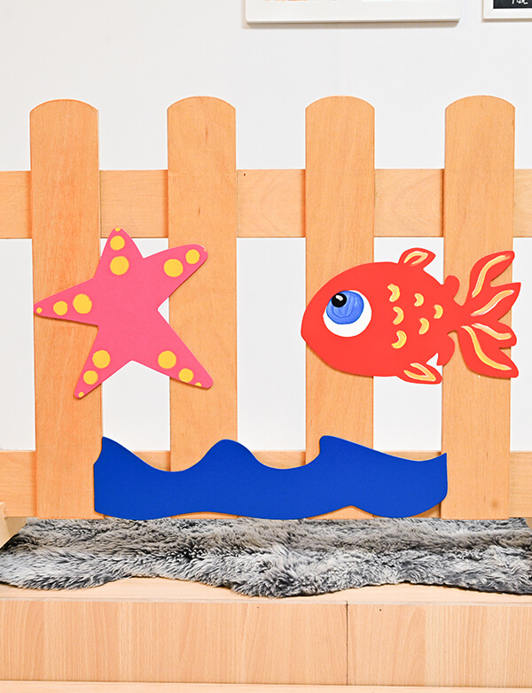 a wooden fence with fish and stars