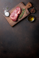 Raw ribeye beef steak cooking with ingredients
