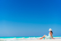 Young woman in hat on the beach