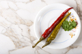 Pickled green and red pepperoni pepper on plate