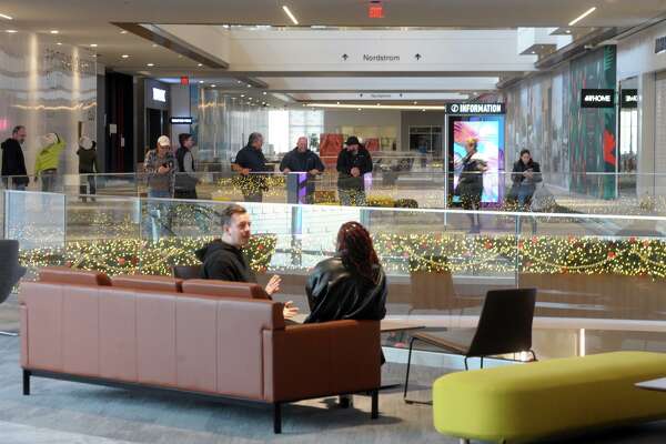 Shoppers relax inside the SoNo Collection mall, in Norwalk, Conn., in mid-November 2019.