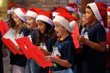 Students from Schneider Elementary School sing Christmas carrols during Montgomery County Precinct 3 Commissioner James Noack's annual Christmas with the Commissioner at The Woodlands Country Club-Palmer Course, Tuesday, Dec. 3, 2019, in Conroe. The toys given during the event will be distributed to children in need around Montgomery County.