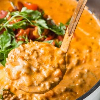 a ladle filled with creamy cheeseburger soup