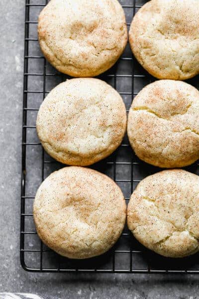 Snickerdoodle cookies on a wire cooling rack.