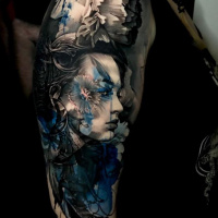 Awesome woman head tattoo on shoulder in black white and blue colors