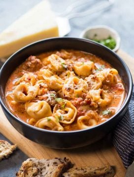 This cosy&nbsp; Sausage Tortellini Soup is delicious and takes less than 15 minutes to make in an Instant Pot. A bowl of Creamy Tomato based broth, Sausage, Cheesy soft Tortellini and a generous sprinkle of parmesan is filling and flavourful.