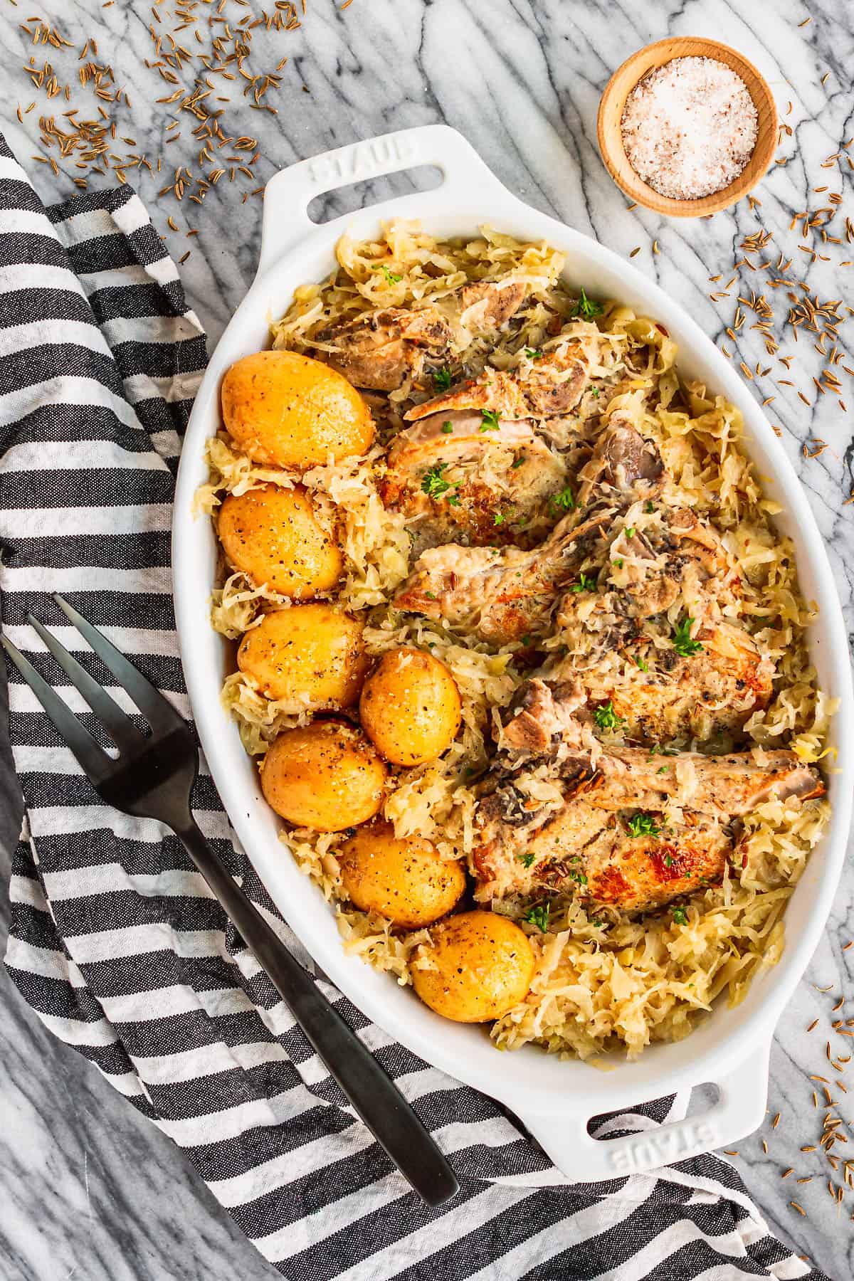 pork chops and sauerkraut made in the slow cooker with a black and white towel