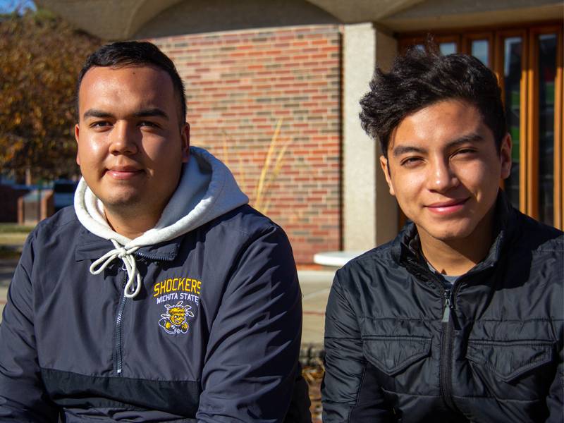 Jonathan Lozano and Javier Martinez sitting outside