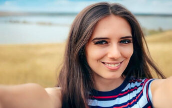 young woman looking happy whilst alone