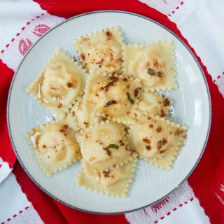 Plate of lobster ravioli on lobster-decorated towel
