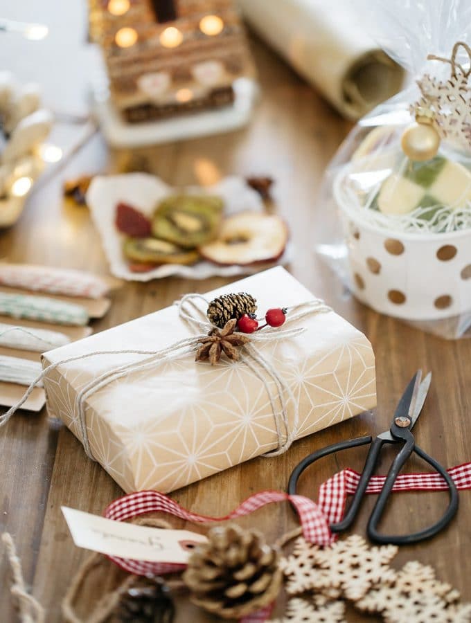 a gift wrapped up in the centre and equipments and wrapping materials sound it.