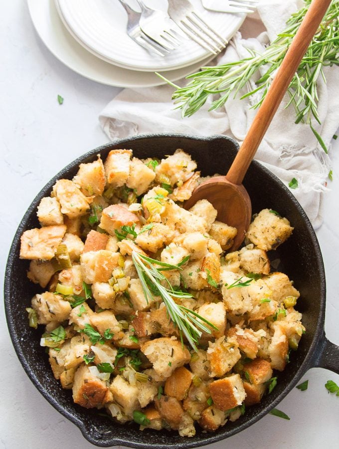 Vegan Stuffing in a Skillet with Wooden Spoon, Fresh Herbs and White Napkin