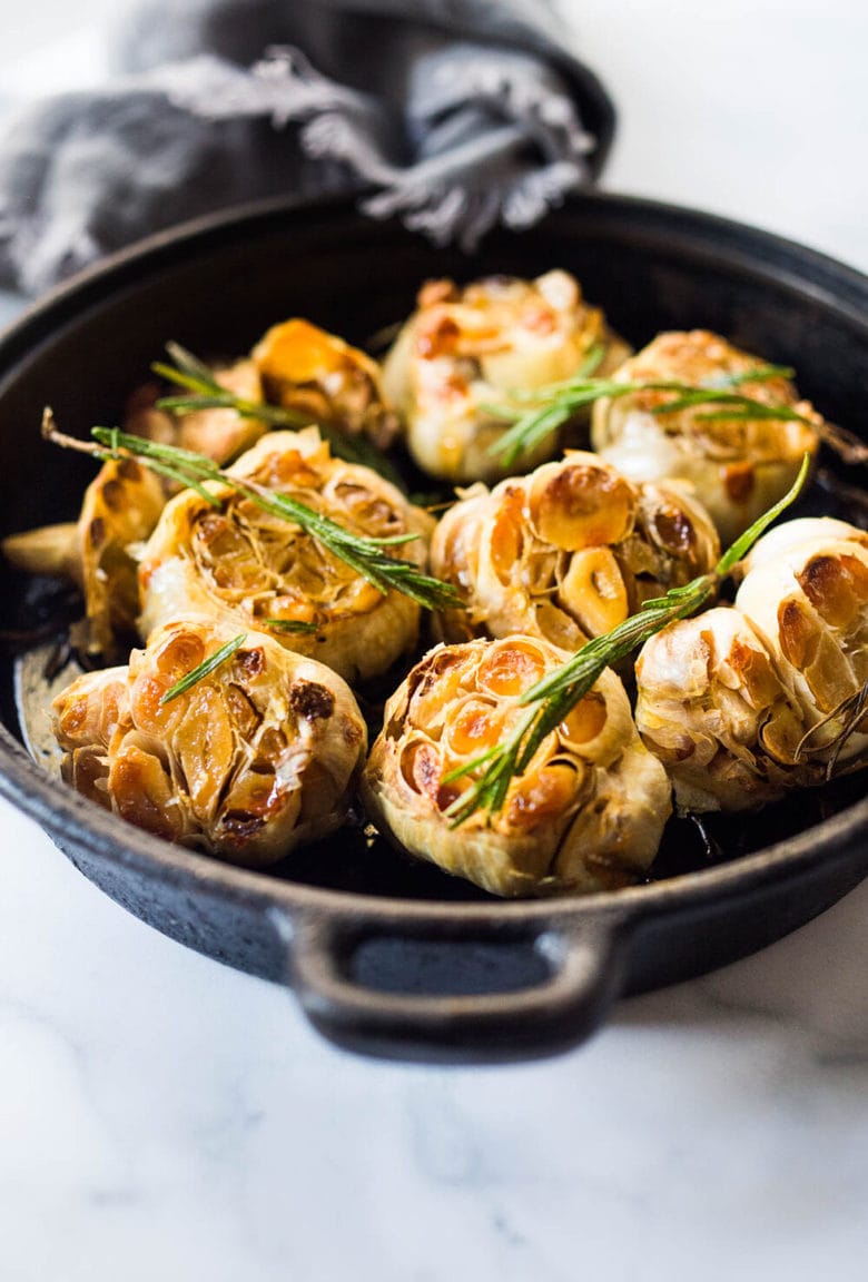 How to Roast Garlic in the oven (using whole heads of garlic or peeled garlic cloves). Roasting garlic transforms it! Spreadable, buttery, sweet, earthy, and complex it has a multitude of uses in the kitchen! And so many health benefits! Whole cloves can be stored in olive oil in the fridge for up to 10 days, or made into a paste, to add to soups, stews, sauces, dressings and mashes.&nbsp;#roastedgarlic #bakedgarlic #garlic #garlicbenefits #roastgarlic