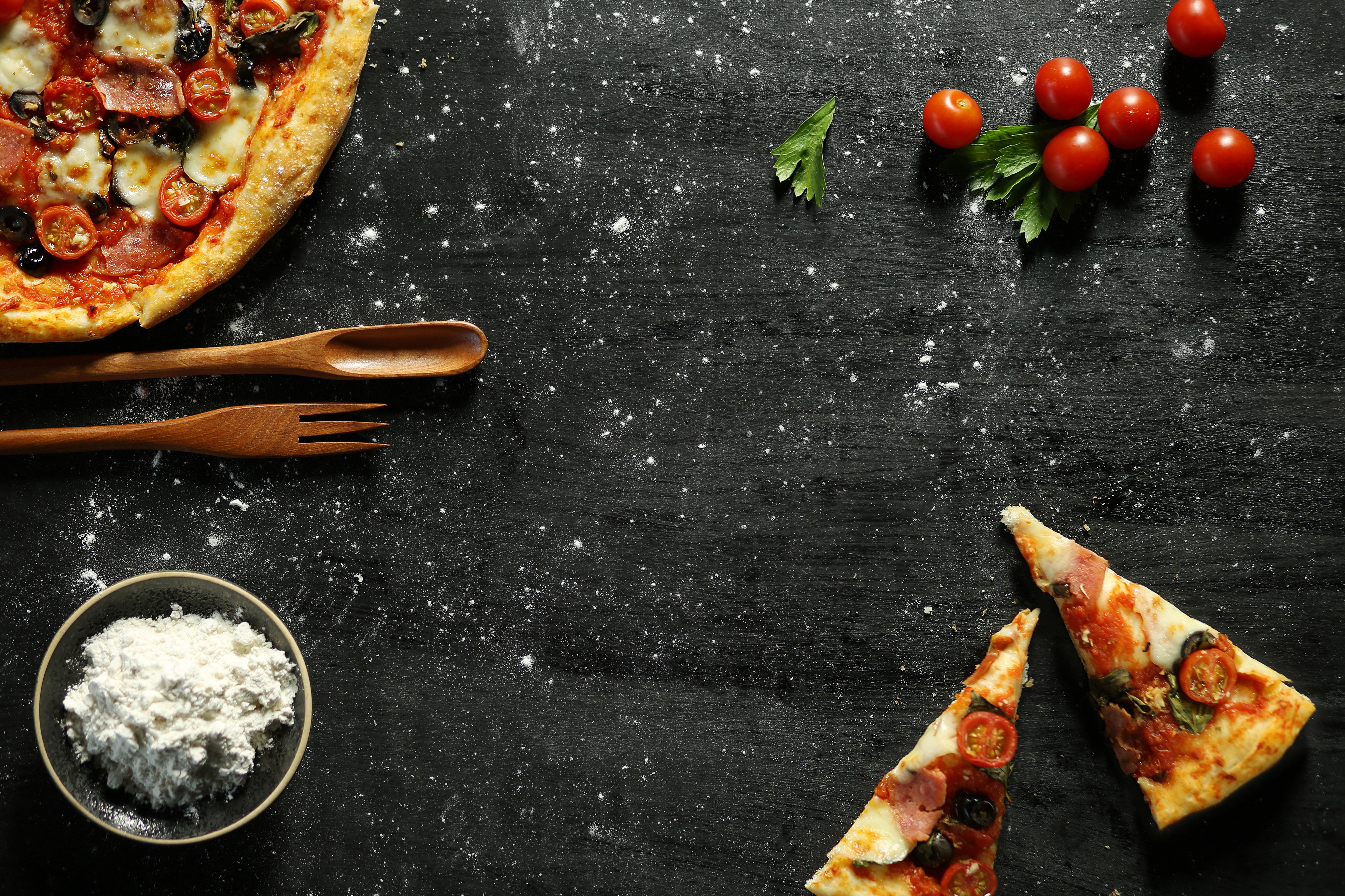 Messy pizza on a black table