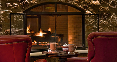 Chairs in front of the fireplace at the Lodge