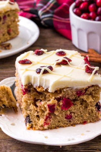 This cranberry Christmas cake is like a Cranberry Bliss Bar - but extra moist with tons of white chocolate cream cheese frosting.
