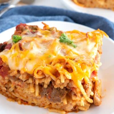 Slice of easy baked spaghetti on a white plate