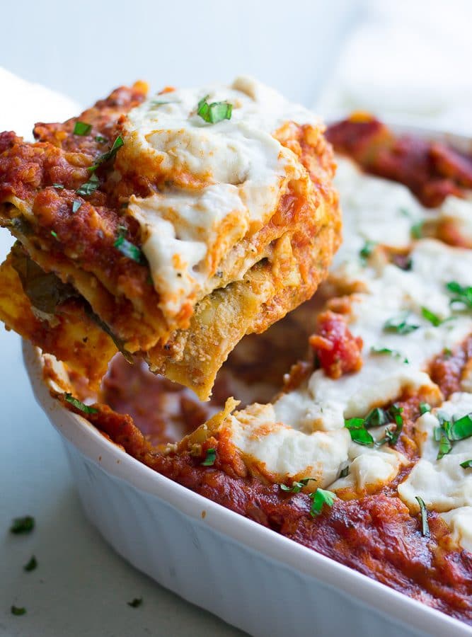 vegan lasagna being picked up from the pan.