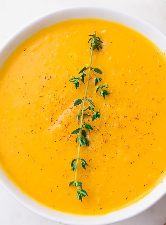 close up of a bowl of instant pot butternut squash soup with thyme