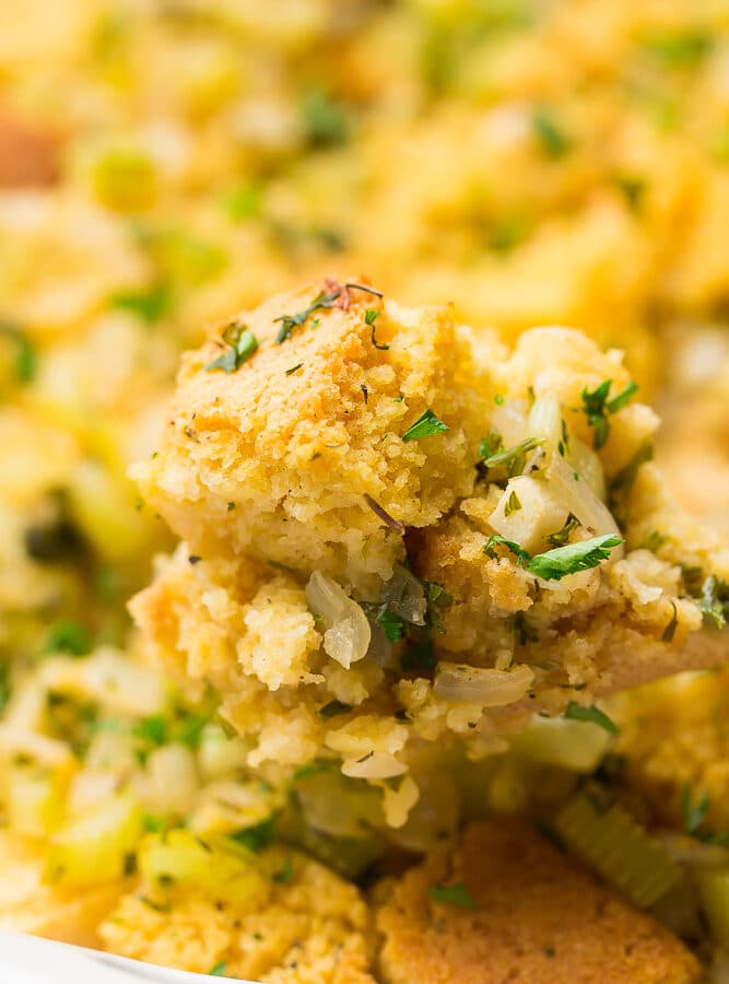 cornbread stuffing on a spoon with casserole in background