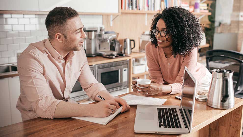 Couple sitting in the kitchen discussing