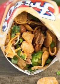 Close up of a Frito snack size bag filled with taco mixture and toppings. Yum!